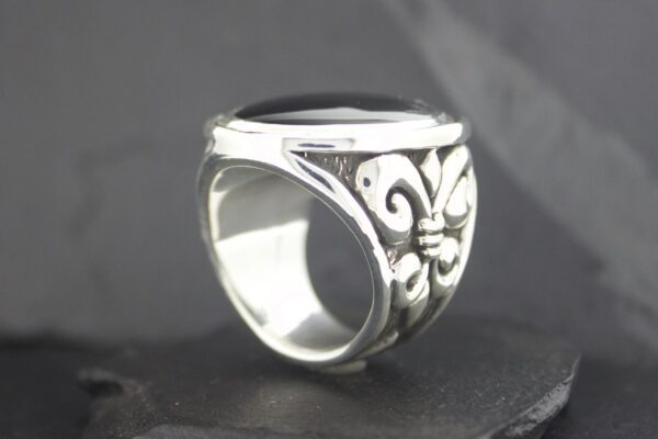 Elegant silver ring with intricate floral design on the band.