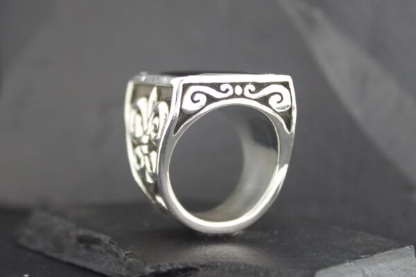 Intricately designed silver ring with elegant scrollwork.