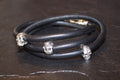 Black leather bracelet with silver skull beads wrapped in a spiral.