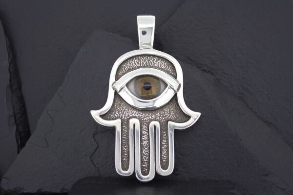 Silver Hamsa pendant featuring a detailed eye design in the center.