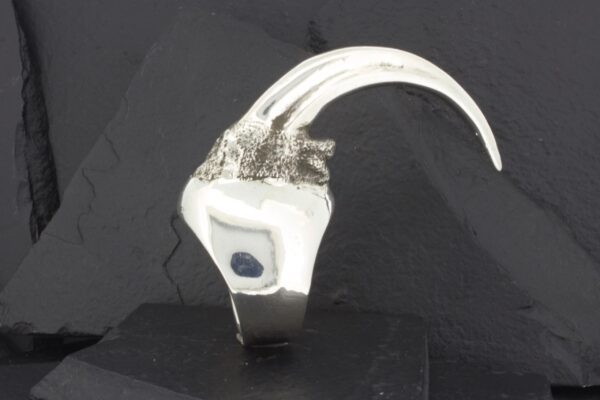 A futuristic white and silver helmet with sleek, curved extensions.