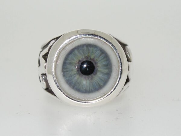 Silver ring with a realistic blue eye design.