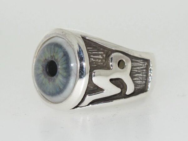 Silver ring featuring a realistic blue eye design.