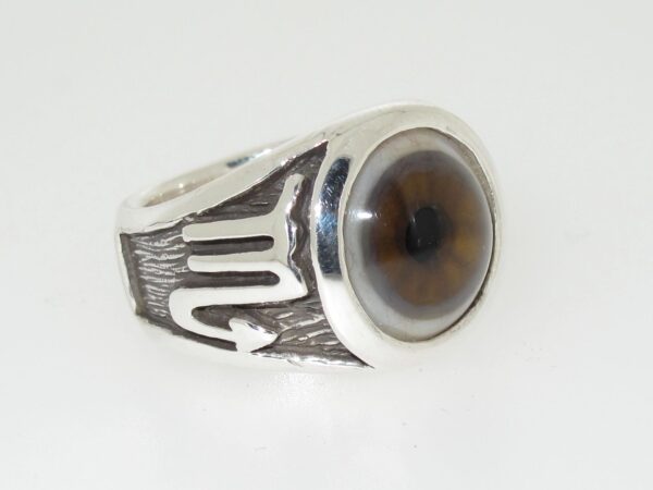 A silver ring with a large, brown, round gemstone.