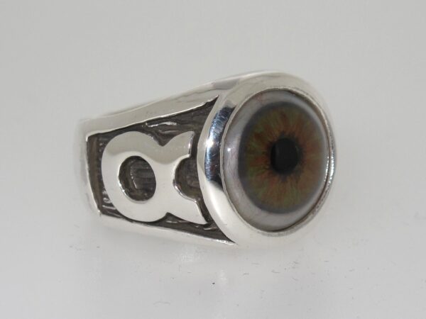 A silver ring with a realistic human eye design.