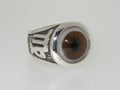 A silver ring with a realistic brown eye design.