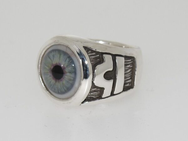 Silver ring with a detailed blue eye design on top.