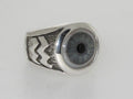 A silver ring with a realistic blue eye design.