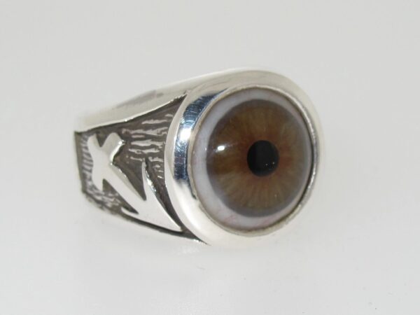 A silver ring featuring a realistic eye design.