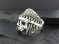 Silver skull ring with Native American headdress design.