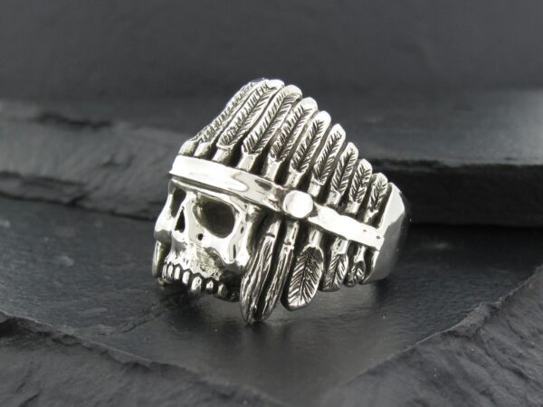 Silver skull ring with Native American headdress design.