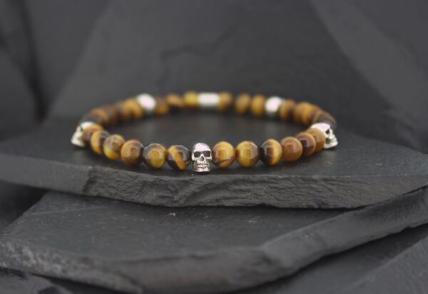Beaded bracelet with tiger eye stones and a silver skull charm.