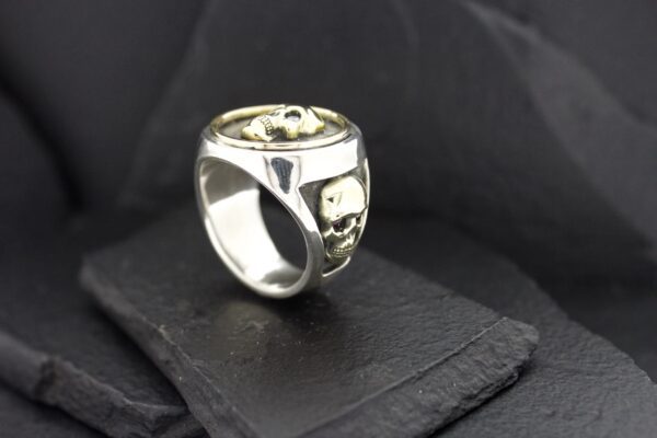 A silver skull ring with intricate detailing.