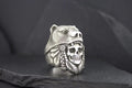 Silver ring featuring a skull with a Native American headdress design.