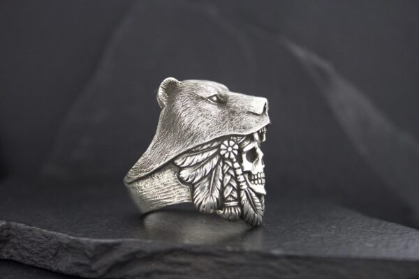 A silver ring featuring a bear head and butterfly wings design.