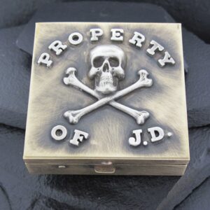 A box with a skull, crossbones, and the text 'Property of J.D.' on it.