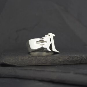 Silver ring featuring a stylized letter 'A'.