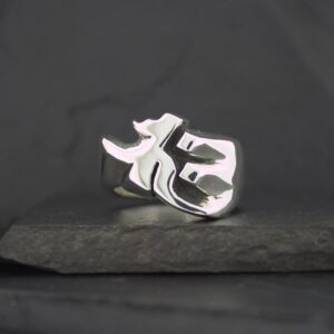 Silver phoenix ring on dark stone surface.