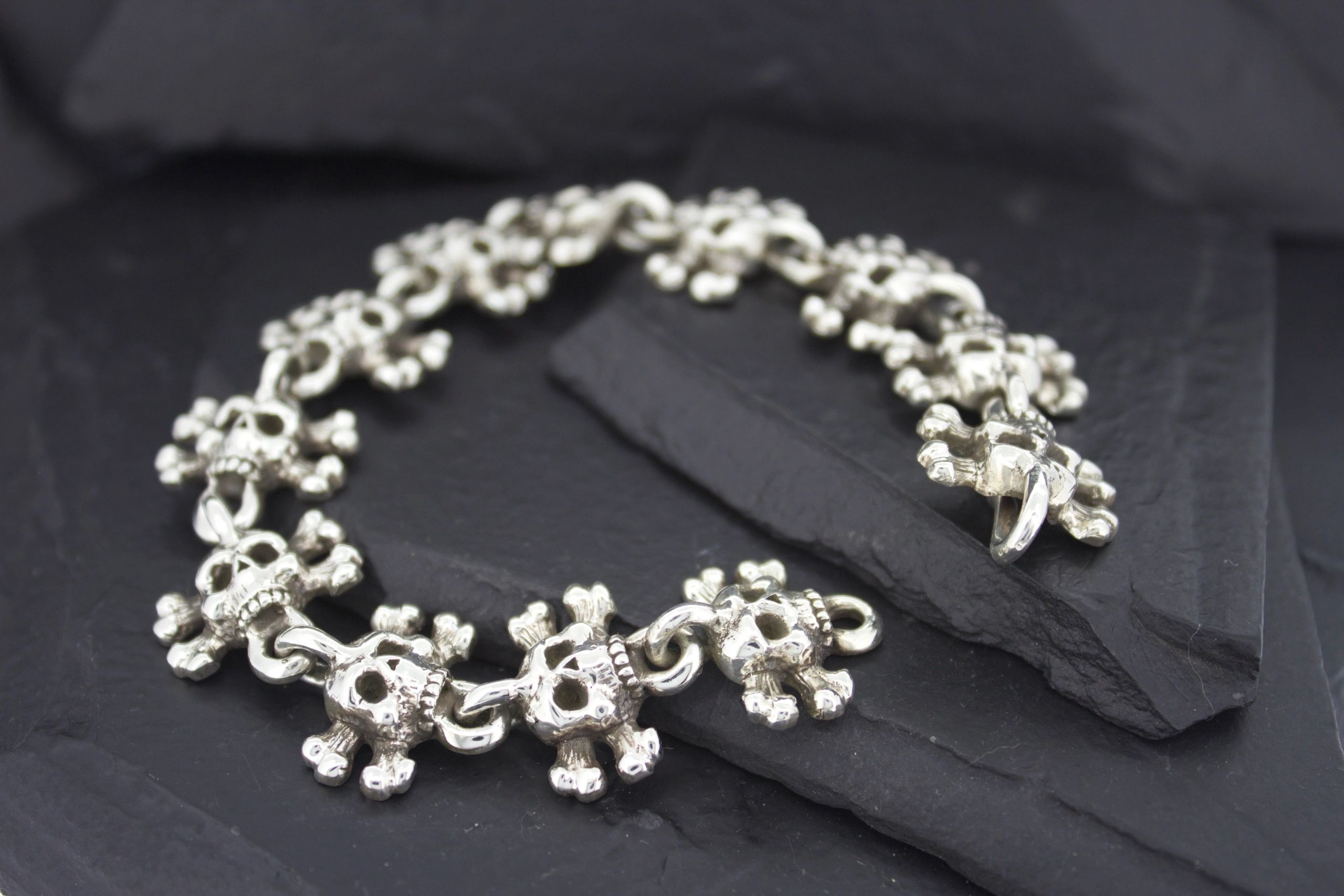 Elegant silver bracelet with intricate floral design.