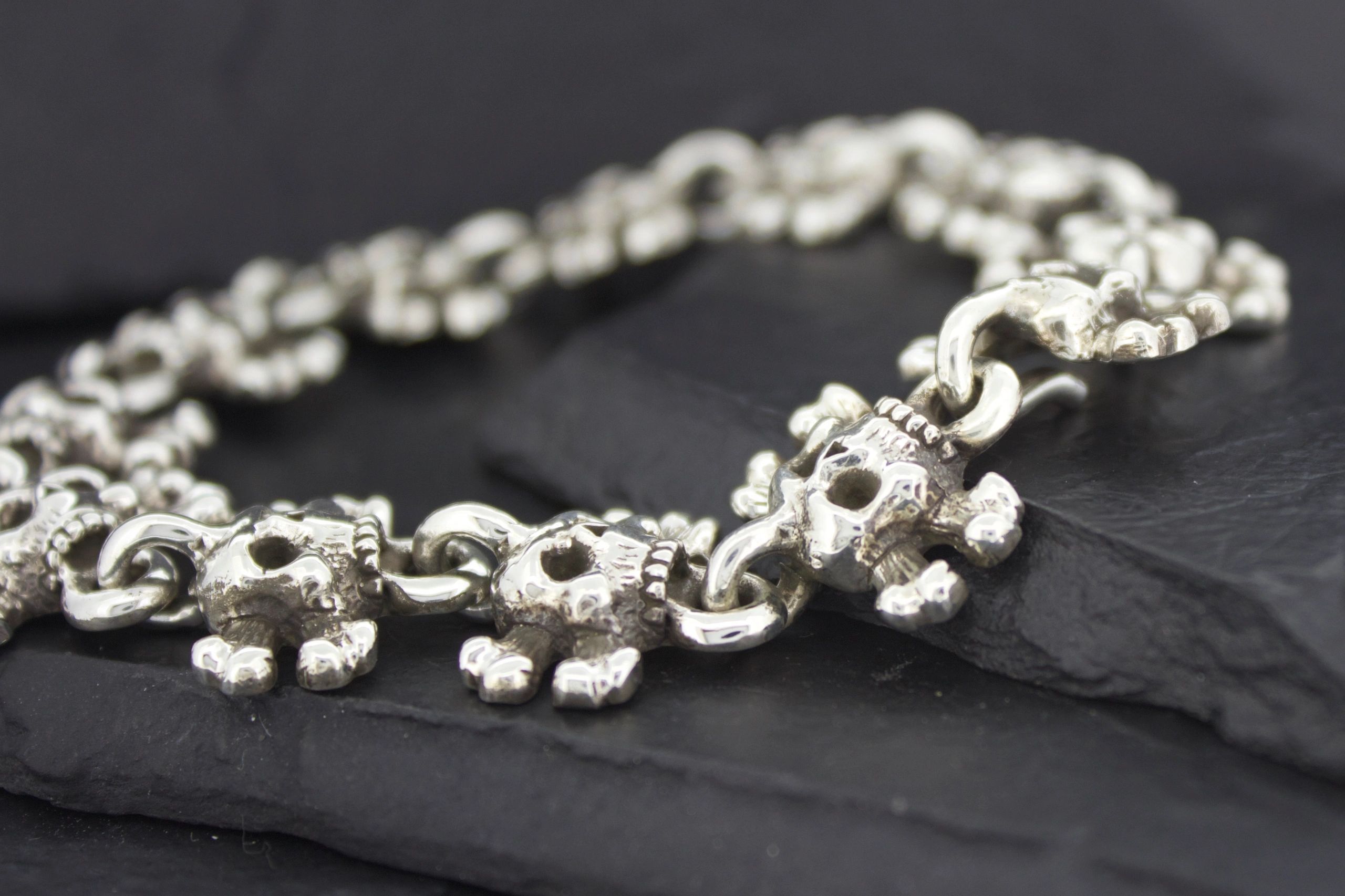 Close-up of a silver bracelet with intricate bead details.