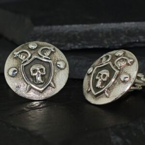 Antique silver cufflinks with skull and crescent moon designs.