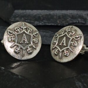 Pair of vintage silver cufflinks with intricate design and letter 'A'.