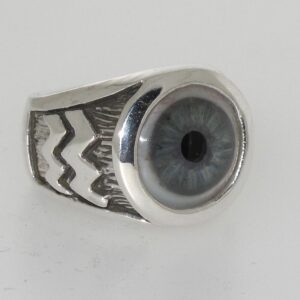 A silver ring with a realistic blue eye design.