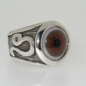 A silver ring featuring a realistic eye design with a snake detail on the band.