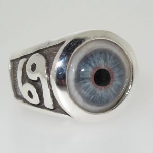 A silver ring with a detailed blue eye design and the number 69 on the side.