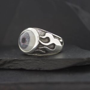 Silver ring with black flame design and round center stone.